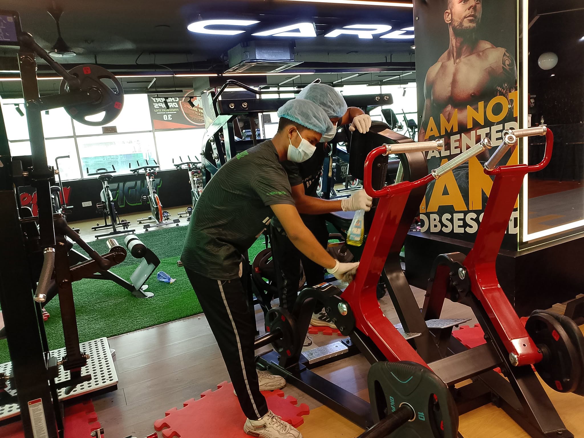 Cleaning of gym equipment in progress