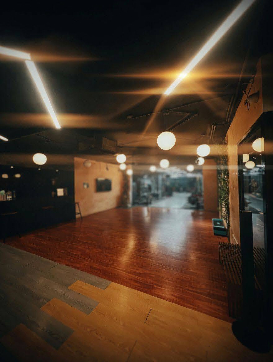 Warm-lit open studio floor at Cherry Drops