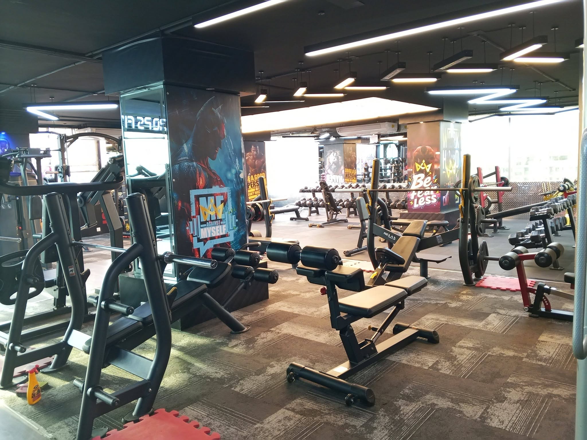 Main training hall with benches, racks and motivational wall graphics