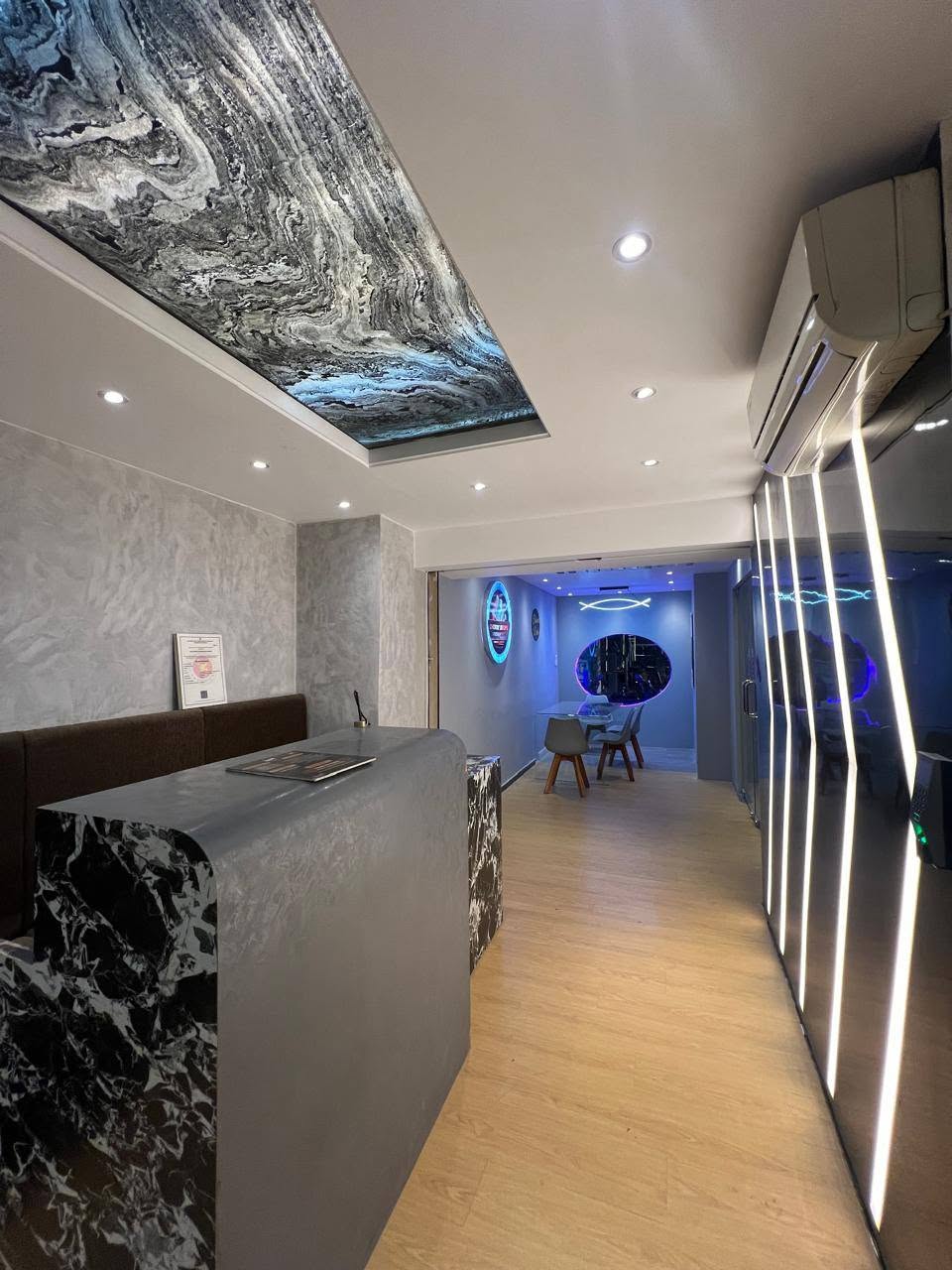 Cherry Drops reception desk with backlit marble ceiling feature and LED walkway